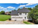 Spacious three-car garage with a basketball hoop, plus a well manicured lawn and established landscaping at 104 Meadow View Trl, Canton, GA 30115