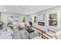 A cozy living area that includes an electric fireplace, modern furnishings, and large windows providing natural light at 2205 Stockbridge Se Dr, Atlanta, GA 30316