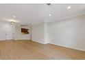 Spacious living room with hardwood floors and a view into the kitchen area, freshly painted at 3334 Peachtree Ne Rd # 101, Atlanta, GA 30326