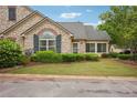 Charming stone home featuring a landscaped front yard, decorative shutters, and well-maintained greenery at 401 Kenley Ct, Mcdonough, GA 30253