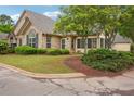 Charming stone home featuring a landscaped front yard, decorative shutters, and well-maintained greenery at 401 Kenley Ct, Mcdonough, GA 30253