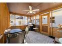 Cozy screened porch with dining table, ceiling fan, grill, and patterned rug at 1019 Henna Se Ct, Conyers, GA 30013