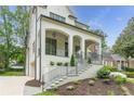 Three quarter view of an exterior elevation with covered front porch with stairs at 1211 Reeder Ne Cir, Atlanta, GA 30306