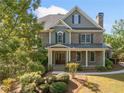 Charming two-story home with a covered front porch surrounded by lush greenery at 3134 Hudson Pond Ln, Marietta, GA 30062