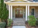 Elegant front entrance with a wood door, brick steps, and white columns at 3134 Hudson Pond Ln, Marietta, GA 30062
