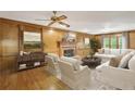 Elegant living room featuring a cozy fireplace, classic wood paneling, and comfortable seating area at 3298 Robinson Oaks Ne Way, Marietta, GA 30062