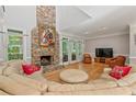 Comfortable living room with a stone fireplace and plenty of natural light at 710 Leeds Garden Ter, Alpharetta, GA 30022