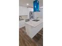Modern kitchen featuring an island with stone countertops, stainless steel appliances, and a distinctive blue range hood at 188 Oak Dr, Atlanta, GA 30354