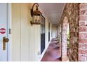 The covered entryway showcases unique brick archways and elegant lighting, enhancing the curb appeal of this inviting home at 2288 Hudson Sw Dr, Lilburn, GA 30047