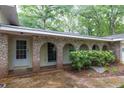 Inviting covered front porch featuring brick arches, providing shade and character to the entrance of this charming property at 2288 Hudson Sw Dr, Lilburn, GA 30047