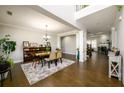 Spacious dining area with hardwood floors, elegant chandelier, and open access to other living spaces at 4041 Woodward Walk Ln, Suwanee, GA 30024