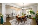 Dining area featuring hardwood floors, large windows, and a view of the outdoors at 4041 Woodward Walk Ln, Suwanee, GA 30024