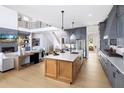 Modern, open kitchen featuring a large island, stainless steel appliances and sleek countertops at 5515 Misty Glen Ln, Cumming, GA 30040
