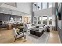 Bright, open-concept living room with high ceilings and seamless flow to kitchen and dining at 5515 Misty Glen Ln, Cumming, GA 30040