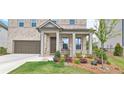 Charming brick home featuring a welcoming front porch and well-manicured landscaping at 2962 Girard Ln, Duluth, GA 30097