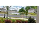 Scenic water view of community pond with lush landscaping, and nearby homes at 2962 Girard Ln, Duluth, GA 30097
