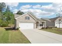 View of a single story brick house with attached two car garage and a driveway on a sunny day at 3382 Long Creek Dr, Buford, GA 30519