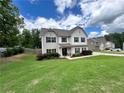 Two-story home with a well-maintained lawn and landscaping at 13 Four Feathers Ln, Rydal, GA 30171