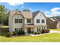 Beautiful two-story home featuring classic architecture and a neatly landscaped front yard on a sunny day at 13 Four Feathers Ln, Rydal, GA 30171