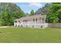 Attractive home with a welcoming front porch and lush green lawn at 37 Winesap Ct, Temple, GA 30179