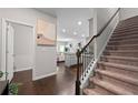 Inviting home entryway featuring hardwood floors, staircase, and open view of the living spaces at 5584 Cannonade Ln, Stonecrest, GA 30058