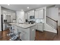 Modern kitchen with granite counters, stainless appliances, island with seating, and ample cabinet space at 5584 Cannonade Ln, Stonecrest, GA 30058