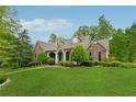 Inviting home with stone accents, a well-kept lawn, and mature landscaping at 6125 Fouts Mill Rd, Douglasville, GA 30135