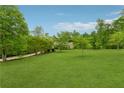 Sprawling front lawn leading up to a home surrounded by lush trees at 6125 Fouts Mill Rd, Douglasville, GA 30135