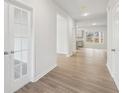 Open-concept view from the hallway leading to the kitchen, with white walls and luxury vinyl plank flooring at 1462 Stephens View Dr, Loganville, GA 30052