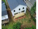 Aerial view of a home's backyard, showcasing a newly constructed wooden deck and ample green space at 2167 Main Nw St, Atlanta, GA 30318