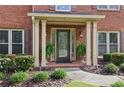 Welcoming front porch with decorative plants and elegant pillars, providing a cozy entrance at 6720 Wolford Ct, Johns Creek, GA 30097