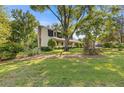 Well-maintained lawn surrounds a home with a classic architectural style and brick chimney at 3527 Starwood Sw Trl, Lilburn, GA 30047