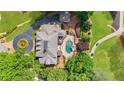 An aerial view that highlights a large in-ground pool, patio area, and the home's manicured landscaping at 5045 Harrington Rd, Johns Creek, GA 30022