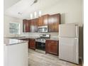 Modern kitchen featuring granite countertops, stainless steel appliances, dark wood cabinets, and recessed lighting at 915 Terance Ave, Jonesboro, GA 30238
