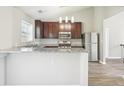 Modern kitchen with dark wood cabinets, granite countertops, stainless steel appliances, and recessed lighting at 915 Terance Ave, Jonesboro, GA 30238
