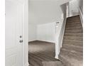 Bright foyer with staircase, hardwood flooring, white door, and natural light streaming in at 2261 Wellington Cir, Lithonia, GA 30058