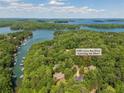 Scenic aerial view showcasing the home's location near a lake and lush greenery, with the address displayed at 3380 Canon Bay Dr, Cumming, GA 30041