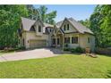 Beautiful home featuring a long driveway, manicured lawn, and an attached two-car garage at 3380 Canon Bay Dr, Cumming, GA 30041
