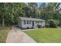 Quaint single-story home with a classic design, complemented by a lush green lawn at 442 Cologne Se Dr, Atlanta, GA 30354