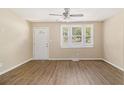 Bright living room featuring new hard wood floors, fan, and natural light from large windows at 442 Cologne Se Dr, Atlanta, GA 30354