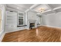 Bright living room with hardwood floors, built-in shelves, fireplace, and coffered ceiling at 1271 Fenway Cir, Decatur, GA 30030