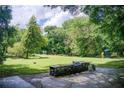 Expansive backyard featuring a stone barbecue area, lush greenery, and space for recreation at 1676 Moores Mill Nw Rd, Atlanta, GA 30327