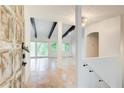 Bright foyer with travertine floors, beams, and neutral colors creating a spacious and inviting entrance at 1676 Moores Mill Nw Rd, Atlanta, GA 30327