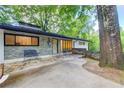 Stylish exterior with stone and painted brick, complemented by an inviting entrance with benches at 1676 Moores Mill Nw Rd, Atlanta, GA 30327