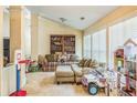 Cozy living room filled with natural light and featuring a comfortable sofa and toys at 2606 Fairmont Park Ct, Dacula, GA 30019