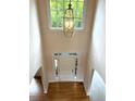 View from above of a foyer with hardwood floors and a statement pendant light at 4091 Oberon Se Ct, Smyrna, GA 30080