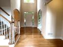 Bright foyer with hardwood floors, high ceilings, and a staircase with white railings at 4091 Oberon Se Ct, Smyrna, GA 30080