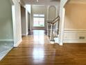 Spacious living room with hardwood floors, wainscoting and an abundance of natural light at 4091 Oberon Se Ct, Smyrna, GA 30080
