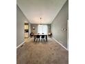 Open dining area with a modern table set, neutral paint, and carpet flooring for cozy Gathering meals at 1736 Almand Creek Sw Dr, Conyers, GA 30094