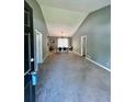 Bright living room with vaulted ceiling, carpet flooring, and a view into the dining area with modern furnishings at 1736 Almand Creek Sw Dr, Conyers, GA 30094